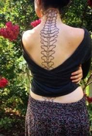 multiple models on the black back of the sexy abstract line spine tattoo