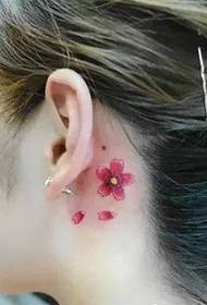small cherry tattoo pattern behind the girl's ear