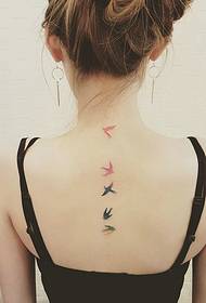 a set of bird tattoo designs above the spine