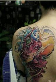 Woman's creative beautiful goldfish tattoo