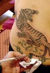 American movie star Angelina behind tiger tattoo pattern
