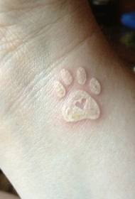 wrist white ink heart-shaped paw print tattoo pattern