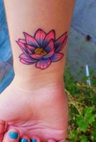 colored lotus tattoo pattern on the female wrist