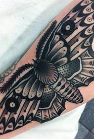 big moth tattoo on the wrist