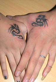 pterosaur tattoo on the wrist of the couple