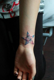 girl's wrist with five-pointed star and starry tattoo pattern