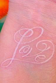 elegant pigeon blood letter tattoo on the wrist