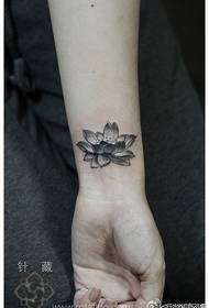 beautiful black gray lotus tattoo pattern at the girl's wrist