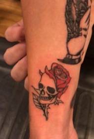 Tattoos on a small boy's calf on a rose and a tattoo picture