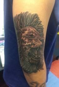 Boy's arm on black gray sketch point thorn trick domineering lion head tattoo picture