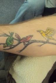 School boy with painted plant branches and bird tattoo pictures
