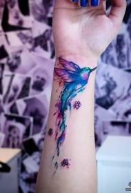 Arm color splashing hummingbird tattoo pattern