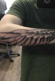 Materiale del tatuaggio ali d'angelo ragazzo braccia sulla foto tatuaggio ali nere