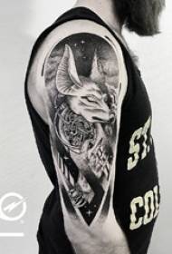 Schoolboy arm on dark grey deer with starry sky tattoo picture