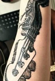 Simple guitar tattoo boy with simple guitar tattoo on arm