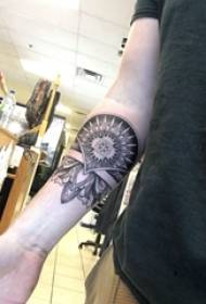 Arm tattoo material, delicate geometric flower tattoo picture on boy's arm