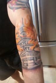 Building tattoo boy's arm on flame and building tattoo picture