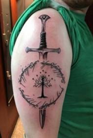 Sword tattoo boy's arm on black tree and sword tattoo picture