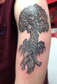 Boys arm on black and white plant pricking tips life tree tattoo pictures