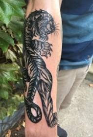 Boys arm on black thorns abstract lines small animal domineering tiger tattoo pictures