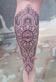 Black intensive geometric mandala tattoo picture on the calf