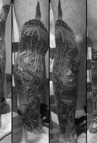 Big jellyfish tattoo with gray ornate design on the legs