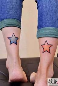 Shiny five-pointed star tattoo on calf