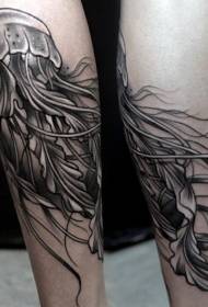 Very realistic black and white jellyfish tattoo on the legs