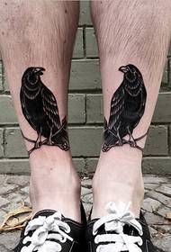 Beautiful black and white crow tattoo pattern on the calf