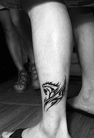 a mini pony totem tattoo tattoo on the calf