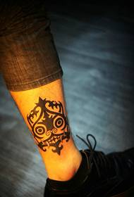 Alternative small totem tattoo on the outside of the calf