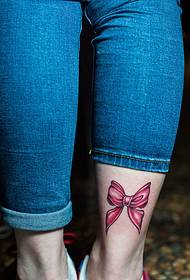 Bow tattoo picture falling on the outside of the calf
