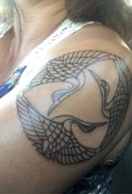Crane tattoo girl's big arm on black crane tattoo picture