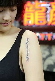 Big arm Sanskrit tattoo for a girl