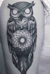 Muchacho do búho tatuaje con un brazo grande na imaxe creativa do búho tatuaxe