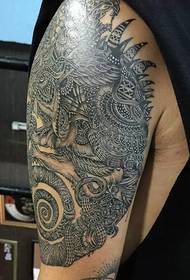 Very cool totem tattoo on the big arm