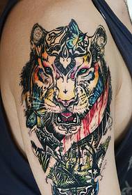 The fierce colored tiger head falls on the man's arm