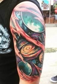 Cosmic tattoo boy's big arm on colored starry sky tattoo picture