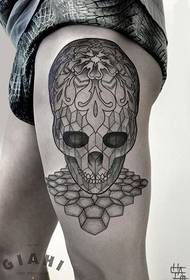 Geometric figure skull tattoo picture of man on left thigh