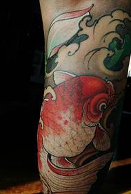 The thigh has a very large red snapper tattoo