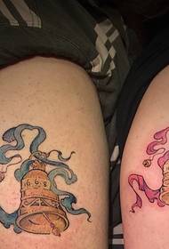 Color couple bells tattoo pattern at thigh