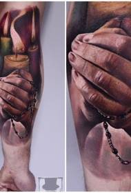 Arm realistic style colorful candle with praying hand tattoo