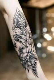 Appreciation of the black gray floral tattoo pattern of the arm