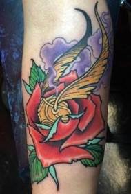 Arm colored rose flower with Quidditch ball tattoo pattern