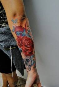 Arm colored rose flower with skull tattoo pattern