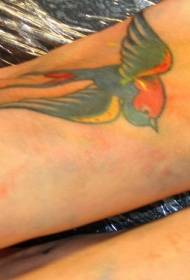 multi-colored swallow tattoo pattern on female instep