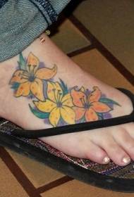 dzeltenu un oranžu ziedu tetovējums uz sieviešu kārtas