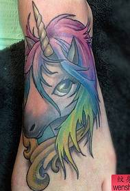 a colorful unicorn tattoo pattern on the instep