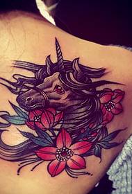 unicorn tattoo on the back of a beautiful woman
