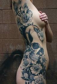 female full nude side waist black and white skull and flower tattoo